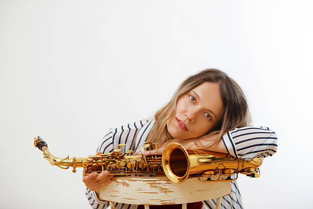 istock female saxophonist resting on saxophone looking into camera 2231667811