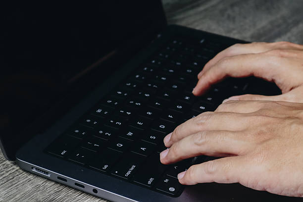 istock Focused Hands Typing on a Laptop Keyboard, Capturing the Essence of Modern Technology in a Minimalistic Workspace 2231668605