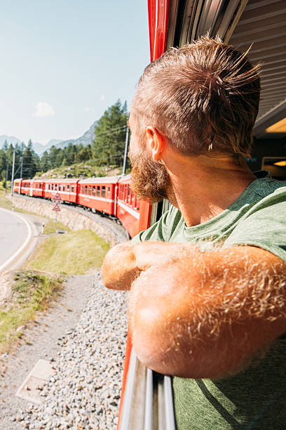 istock Man Enjoying Scenic Mountain Train Ride 2231670065