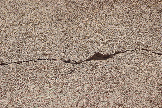 Old layers of Weathered and cracked concrete raw building wall, modern original texture background. Unfinished dirty with many imperfections. Design elements often used pattern in interior and building architecture. Good material and abstraction as background \