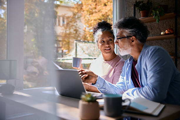 istock Senior couple using laptop and drinking coffee at home 2231674294
