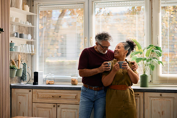 istock Happy senior couple drinking coffee in kitchen 2231674431