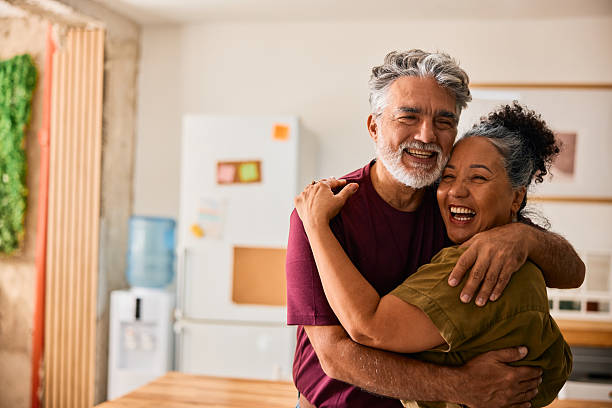 istock Happy senior couple hugging and laughing in the kitchen 2231674531