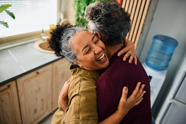 istock Happy senior couple hugging in the kitchen 2231674637