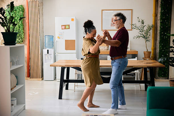 istock Happy senior couple dancing together in the kitchen 2231674903