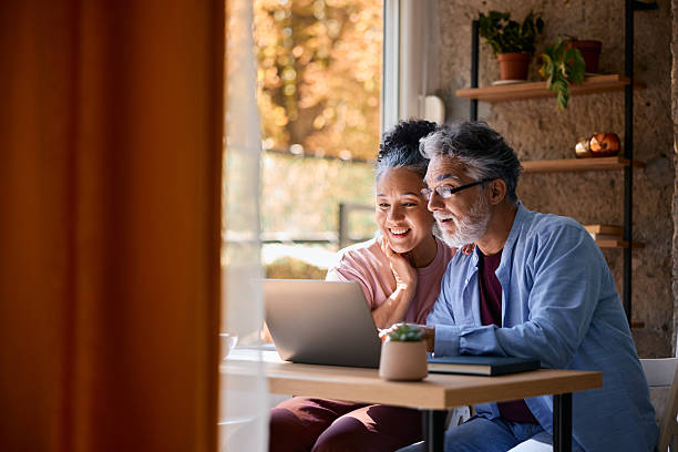 istock Happy senior couple using laptop at home 2231674933