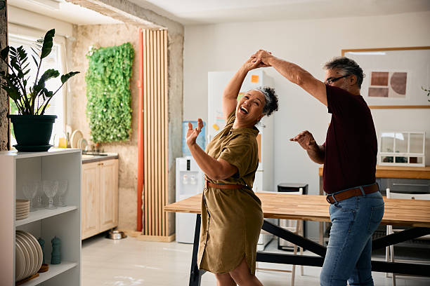 istock Happy senior couple dancing in the kitchen 2231674984