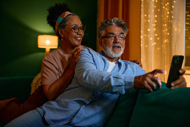 istock Happy senior couple using smartphone at home 2231675720