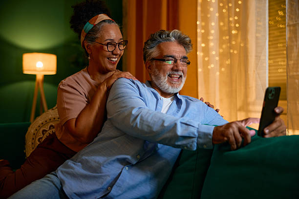istock Happy senior couple using smartphone at home 2231675754