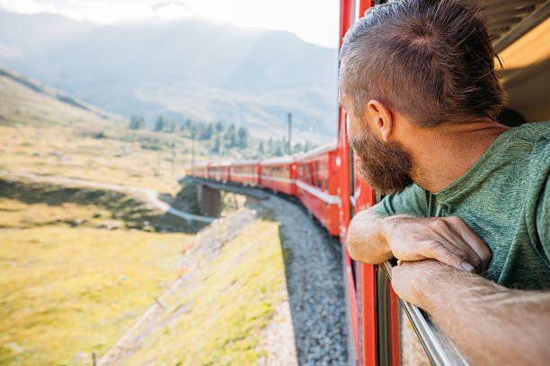 istock Man Enjoying Scenic Mountain Train Ride 2231676189