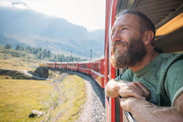 istock Man Enjoying Scenic Mountain Train Ride 2231676223