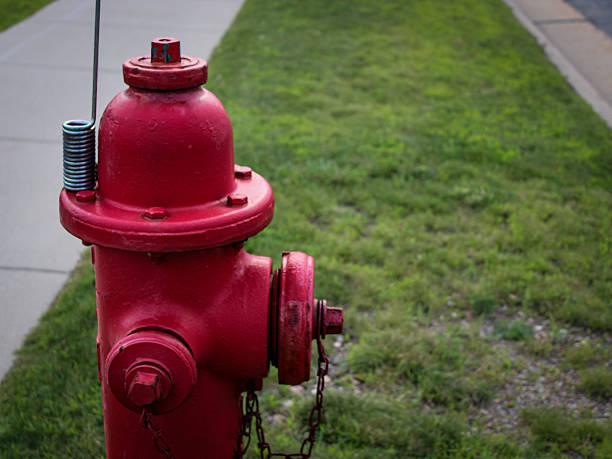 istock closeup of a vibrant red fire hydrant in front of a sidewalk with copy space.  i 2231677676