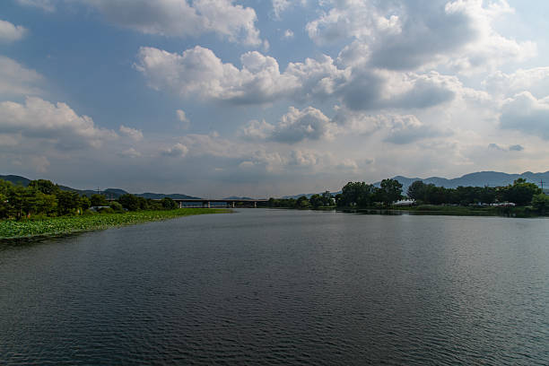istock calm lake with bridge and clouds 2231680226