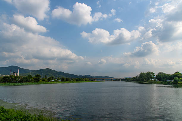 istock calm lake with bridge and clouds 2231680249