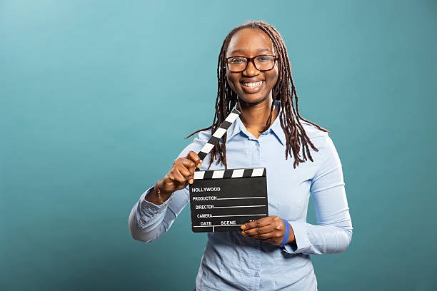 istock Cheerful filmmaker holding clapperboard 2231680640
