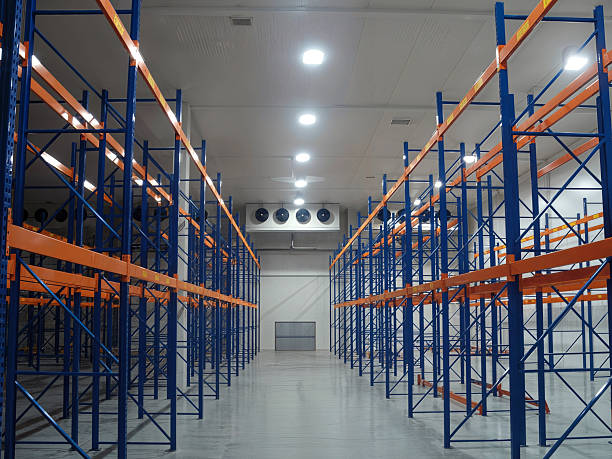 istock Inside a spacious, industrial warehouse with rows of empty storage racks ready to be filled. 2231681561
