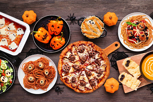 istock Spooky Halloween dinner party table scene over a dark wood background 2231682521