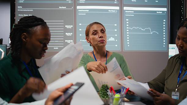 istock Close up of diverse business team meeting after hours for visual data reports 2231683659