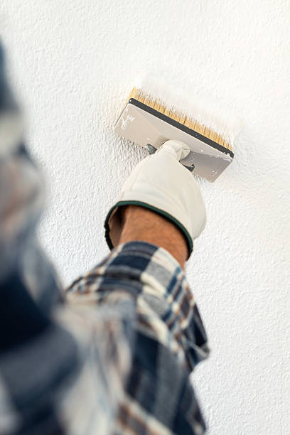 istock House painter worker painting a wall white. Building. 2231683848