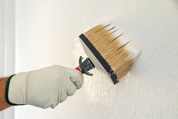 istock House painter worker painting a wall white. Building. 2231683855
