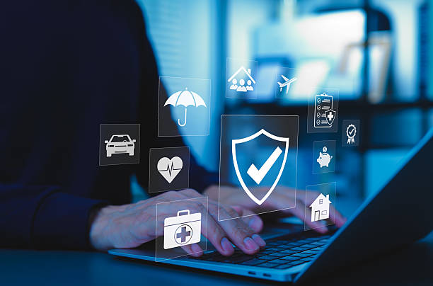 istock Insurance concept. A person using a laptop with various digital icons representing different types of insurance, such as health, home, car, travel, life, comprehensive coverage, and policy management. 2231685029