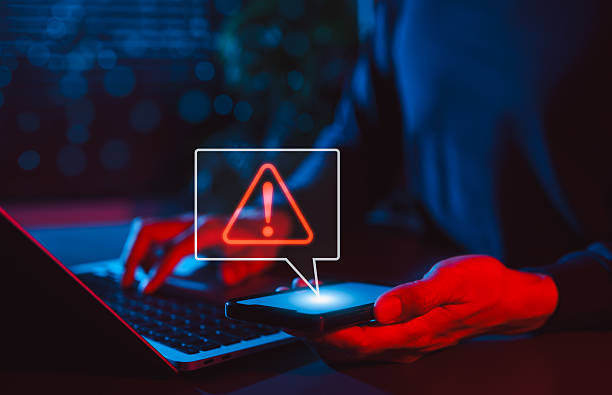 istock Mobile Security Alert and Cyber Threat Notification. Man holding smartphone with red warning sign and exclamation mark, symbolizing secure, system errors, hacking alerts, and online data protection. 2231685038