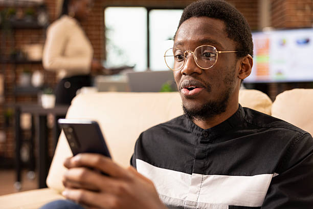 istock Surprised businessman looking at mobile phone 2231685543
