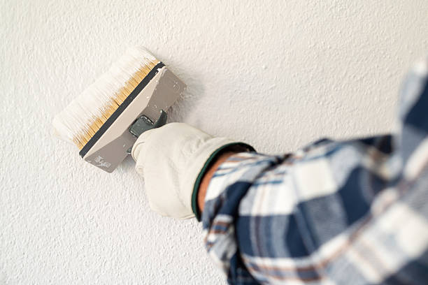 istock House painter worker painting a wall white. Building. 2231685552