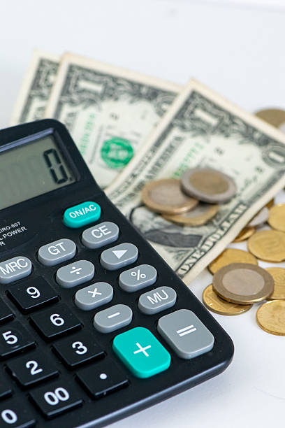 istock Budget Calculation with Calculator, Dollar Bills and Coins on White Background 2231687325