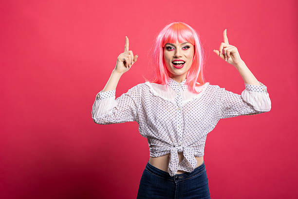 istock Happy gorgeous woman pointing upwards 2231687466