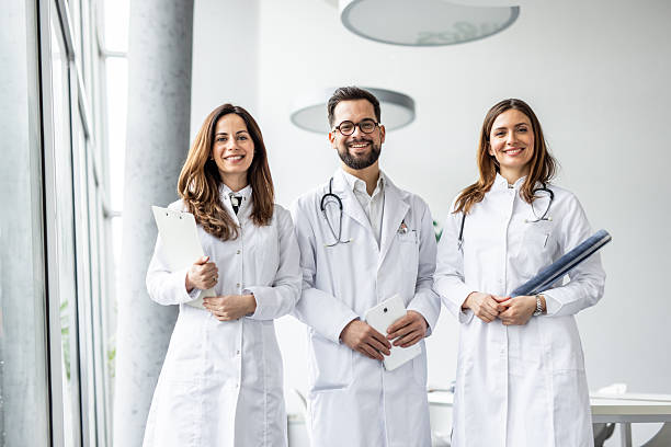 istock Smiling doctors posing together in modern hospital 2231687583
