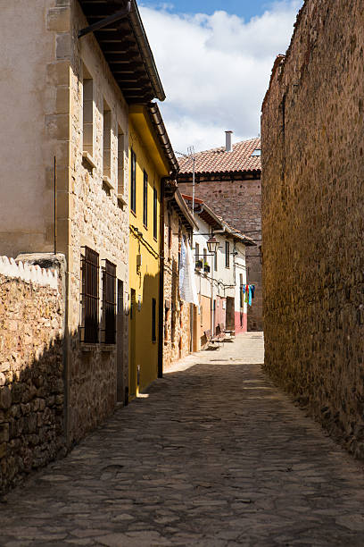 istock Quiet cobblestone street lined with historic buildings under a clear sky 2231687883