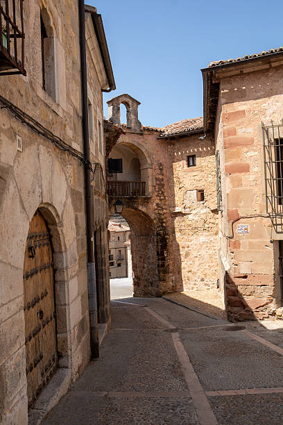 istock Quiet cobblestone street lined with historic buildings under a clear sky 2231687899