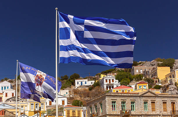 istock Greek Flag Flying Over Symi, Greece 2231691671