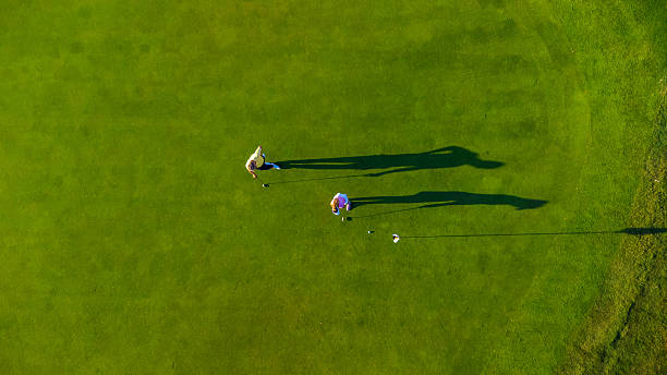 istock Golfers playing on green grass field on sunny day 2231696339