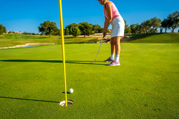 istock Golfer putting ball on the green on sunny day 2231696430