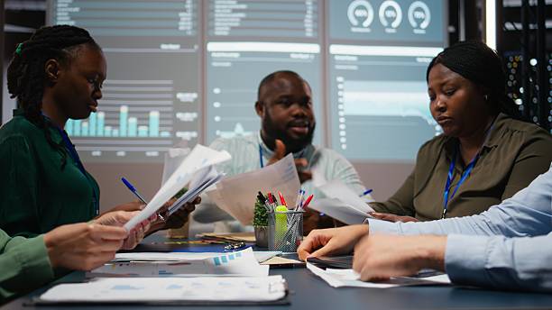 istock Close up of diverse specialists evaluating data numbers on archived files 2231699488