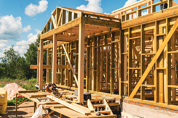 istock Wooden frame house under construction on sunny summer day 2231701699