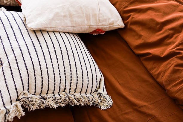 istock Soft textured pillows and warm bedding create a cozy atmosphere in a bedroom setting 2231706518