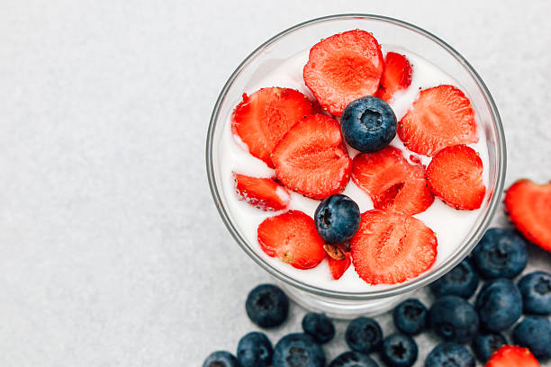 Delightful dessert featuring fresh strawberries and blueberries in a glass bowl