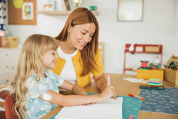 istock Mother checking glucose level on daughter's glucose meter 2231709045