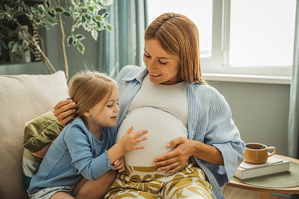 istock Pregnant mother and her daughter hugging 2231709173