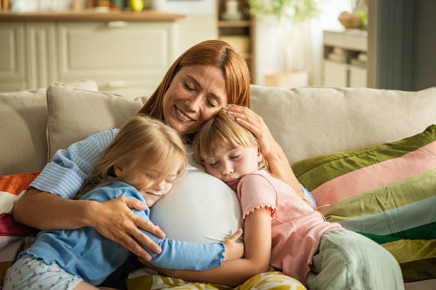 istock Pregnant mother and her daughters hugging 2231709333