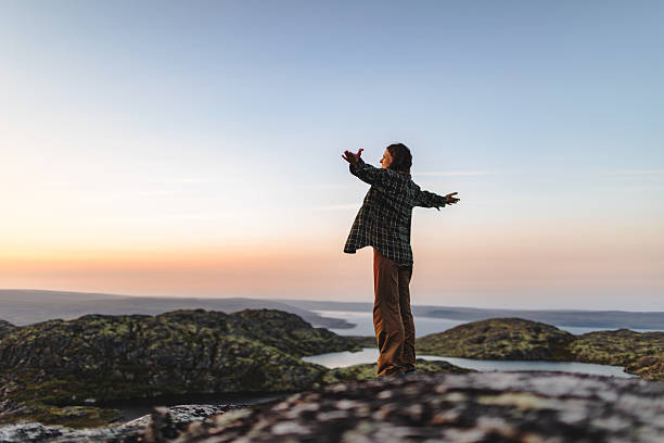 istock Young woman enjoying sunset at lakes 2231710476