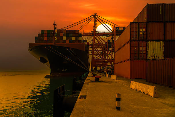 Cargo ship entering the port of Santos while a tugboat accompanies.