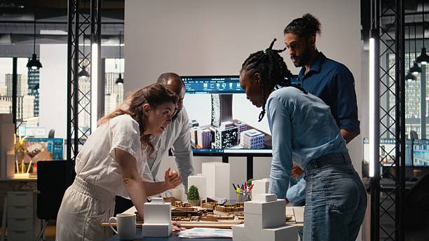 Close up of developers arranging 3D models to explore residential layout