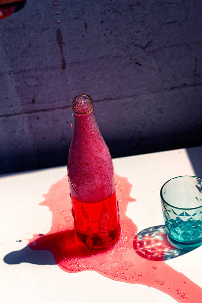istock Red liqueur in a bottle and glass on a white tabletop. 2231726613
