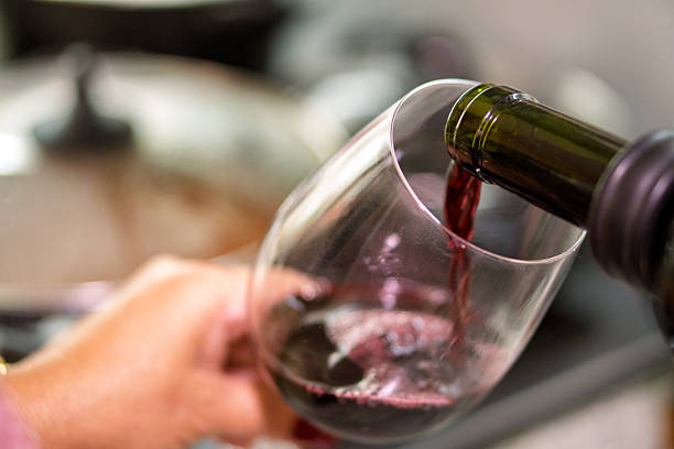 istock Pouring red wine into a glass for lunch 2231728138