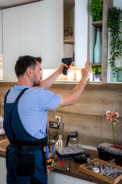 istock Skilled worker installs cabinetry in modern kitchen during afternoon renovations 2231729837