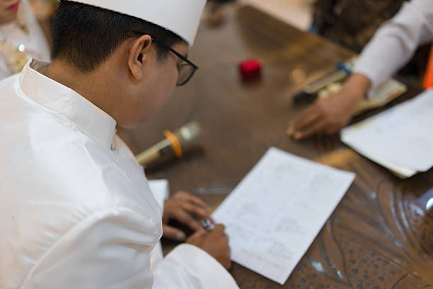 close-up of hands working on a table in an office writing in a notebook analyzing materials